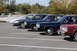 1991 Mercury Marquis - Four sedans are parked in a lot, showing their side profiles. The red sedan is in the foreground.