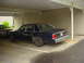 1991 Mercury Marquis - The rear of a 1991 Mercury Marquis is visible, parked in a carport next to another vehicle.