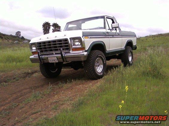 White and green 1978 Ford Bronco with "78 BRONCO" license plate