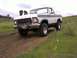 1978 Ford Bronco - This 1978 Ford Bronco, identified by its license plate, is shown off-road in a grassy, hilly landscape.