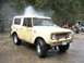 1966 International Scout 800 - A 1966 International Scout 800 is pressure washed in a driveway, showing its distinctive grille and body style.