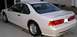 1994 Ford Thunderbird - The rear three-quarter view of a white 1994 Ford Thunderbird coupe is shown.