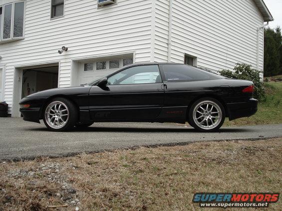 Black 1993 Ford Probe GT side view with aftermarket wheels