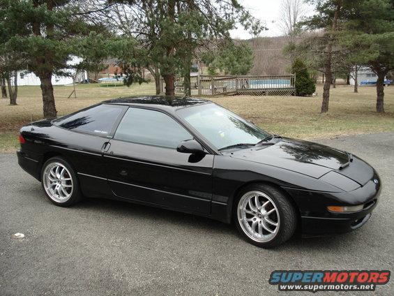 1993 Ford Probe coupe with aftermarket wheels parked on a driveway