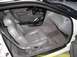 1994 Ford Thunderbird - The interior of a car features gray leather seats, carpet, and a visible steering wheel and center console.
