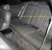 1994 Ford Thunderbird - The interior of a car shows gray leather seats and carpeting, with a handwritten note on the seat.