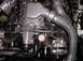 1994 Ford Thunderbird - Close-up view of a vehicle's engine bay, highlighting the intake manifold and supercharger piping.