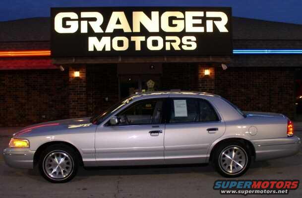 1999 Ford Crown Victoria side view parked in front of Granger Motors dealership
