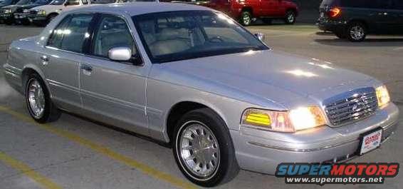 Silver sedan parked in a lot, front quarter view. Other cars visible in background