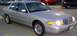 1999 Ford Crown Victoria - This sedan has a distinctive grille and headlight design, indicating a specific model year.