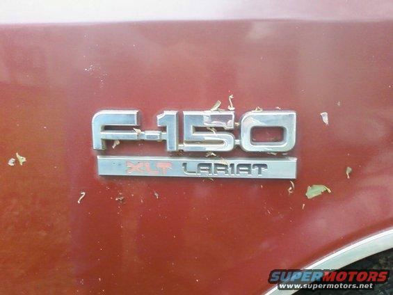 Red F-150 XLT Lariat badge on vehicle side