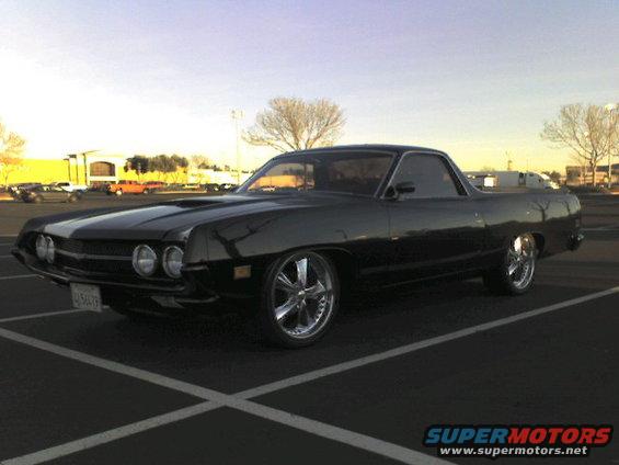 Black 1970 Ford Ranchero with chrome wheels parked in a lot