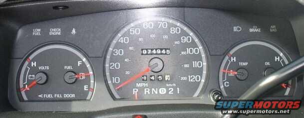 1999 Ford Crown Victoria dashboard with speedometer, fuel gauge, voltmeter, oil temp, and water temp gauges