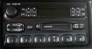 Car radio with AM/FM, seek, tune, scan, and CD buttons. Also has numbered presets