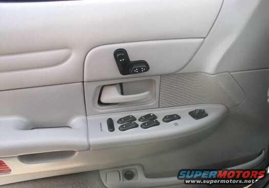Driver's side door panel with window and lock controls. This is a 1999 Ford Crown Victoria