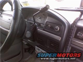 Interior view of a vehicle dashboard with a CB radio and SuperMotors logo