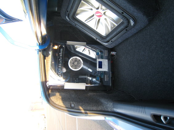 Car trunk with Kicker subwoofer and custom audio amplifier setup