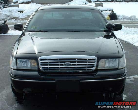 Black 1998 Ford Crown Victoria front view, grille with Ford logo, snow in background