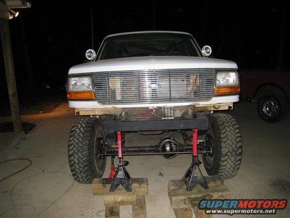1996 Ford Bronco front end raised on jack stands, showing suspension modification