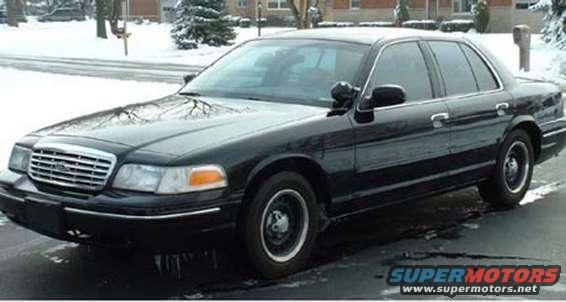 Black 1998 Ford Crown Victoria sedan in snowy conditions, front 3/4 view