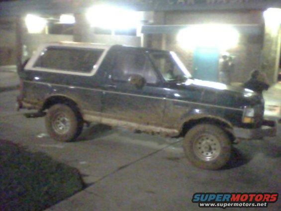 1993 Ford Bronco parked at night, side view