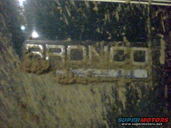 Bronco emblem covered in mud