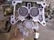 1978 Ford Bronco - Close-up view of a carburetor, showing its internal components and throttle plates.