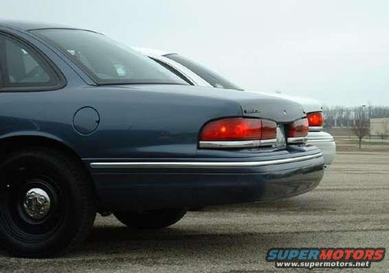 Blue 1998 Ford Crown Victoria rear quarter panel and taillight, another car behind