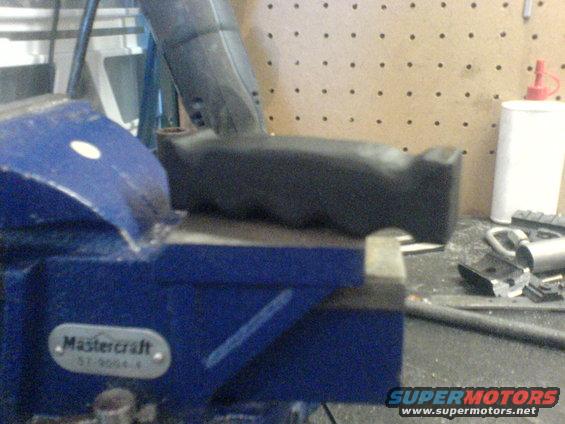 Black handle held in a blue Mastercraft vise