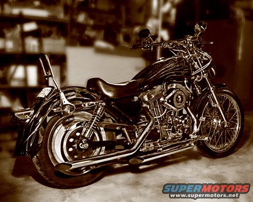Motorcycle with flames on tank, chrome details, and spoked front wheel