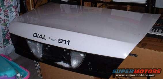 White car hood with black lower section, "DIAL 911" text, and headlights