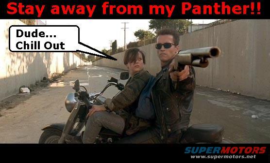 Two people on a motorcycle, one holding a shotgun