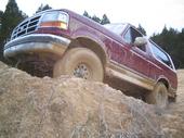 1992 Ford Bronco climbing a dirt hill