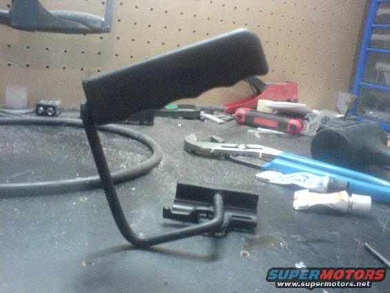 Black eyeglasses with a metal frame resting on a glass table
