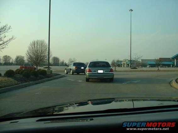 Gray Ford Crown Victoria from rear, parked in a lot