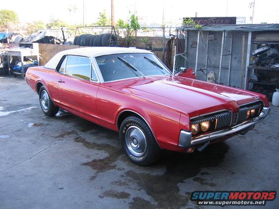 Red 1969 Cougar with white vinyl top, 3q-front view