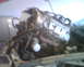 1999 Ford Mustang - An engine is being hoisted out of a vehicle, likely for repair or replacement.