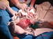 1981 Ford Bronco - Newborn baby receiving medical attention, with text 'SUPERMOTORS.NET' visible at the bottom.