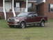 2005 Ford F-150 - Maroon 2005 Ford F-150 pickup truck with tan trim parked in front of a residential home.
