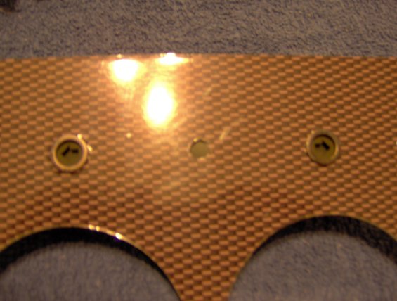 Dashboard panel with carbon fiber pattern, two gauge openings, and screw holes