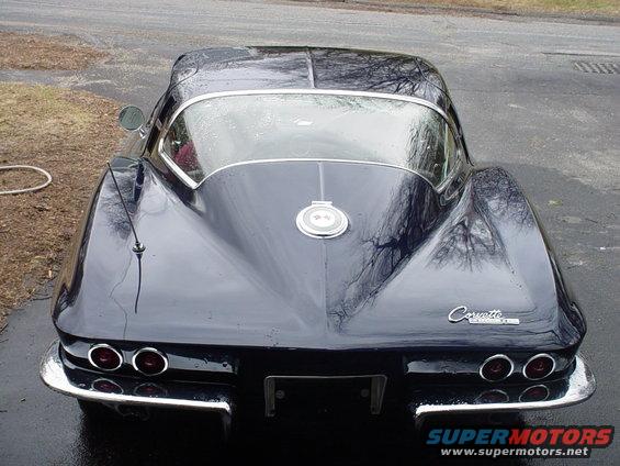 Dark blue Chevrolet Corvette rear view, chrome bumper, quad taillights, "Corvette" script