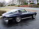 1964 Chevrolet Corvette - The rear quarter panel and distinctive split-window design are visible on this classic coupe.
