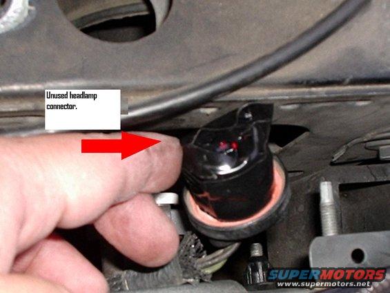 r4.jpg Unused factory headlight socket.