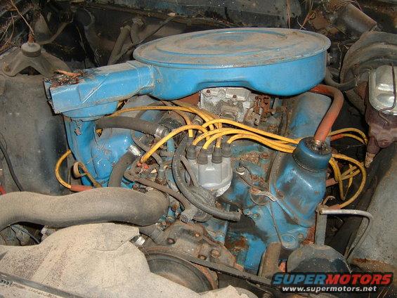 Engine bay with blue painted engine block, yellow spark plug wires, and air cleaner