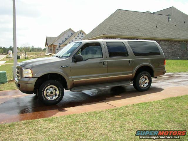 Ford Excursion SUV parked on a driveway, with houses under construction in the background