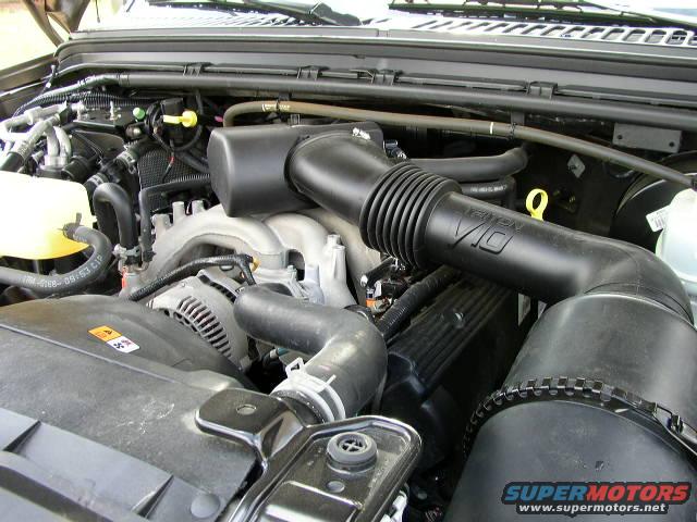 Engine bay with V10 intake tube and alternator visible. Supermotors.net logo at bottom right