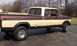 1979 Ford Bronco - This pickup truck features a crew cab and a long bed, with chrome wheels and trim.