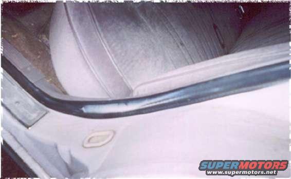 Interior view of a car's seat and door panel with a Supermotors.net watermark