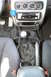 1996 Ford Probe - Interior view of a car's center console, a manual gear shifter and aftermarket stereo system.