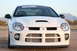 1996 Ford Probe - A white Dodge Neon SRT-4 is shown from the front, with a scoop on the hood and intercooler behind the grille.